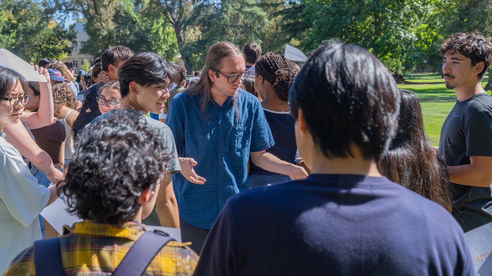 Graduate student Devin Romines leads an outdoor discussion with peers during a FUSE program teaching activity.