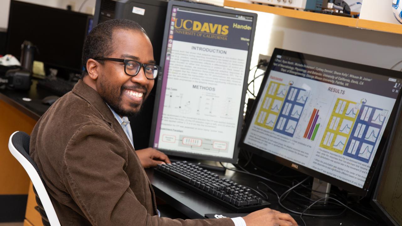 Associate Professor Wilsaan Joiner explores sensorimotor integration: how sensory inputs, like vision, influence our motor actions and vice versa. David Slipher/UC Davis Wilsaan Joiner sits at his desk