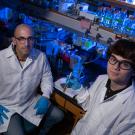 Professor Ken Kaplan and student Mackenzie Noon sit in the lab