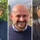 Three men standing outdoors in separate settings, arranged side by side in a composite image. The man on the left wears glasses and a navy blue polka dot shirt. The man in the center is bald, smiling, and wears a dark sweater over a collared shirt. The man on the right wears glasses, a blue button-up shirt, and a gray blazer.