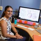 Priya Shah at her desk with a computer