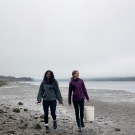 Two young women walking on a beach